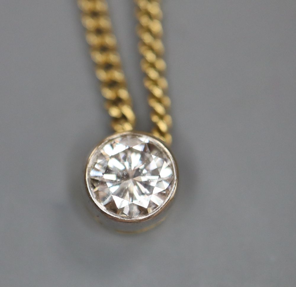 An 18ct gold and solitaire diamond pendant necklace, gross 5.8 grams.